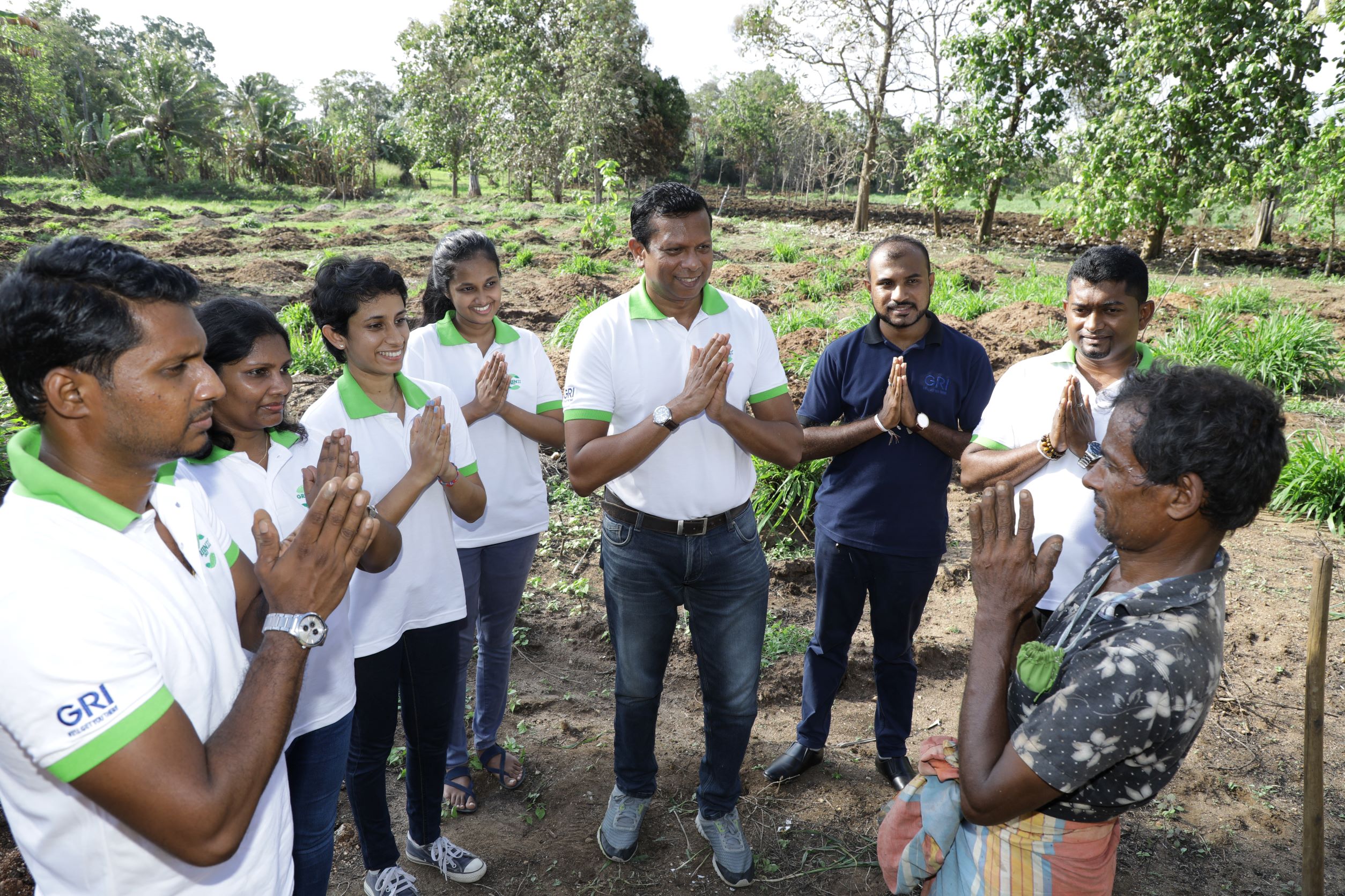 The GREEN X CIRCLE team greeting a rubber farmer 